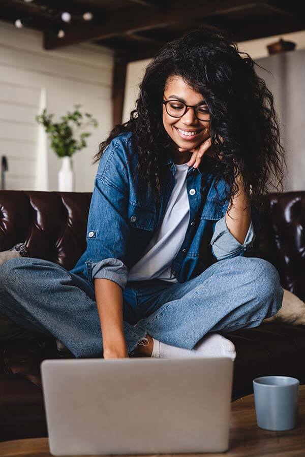 A woman using Foothill Credit Union Online Banking services from her home.